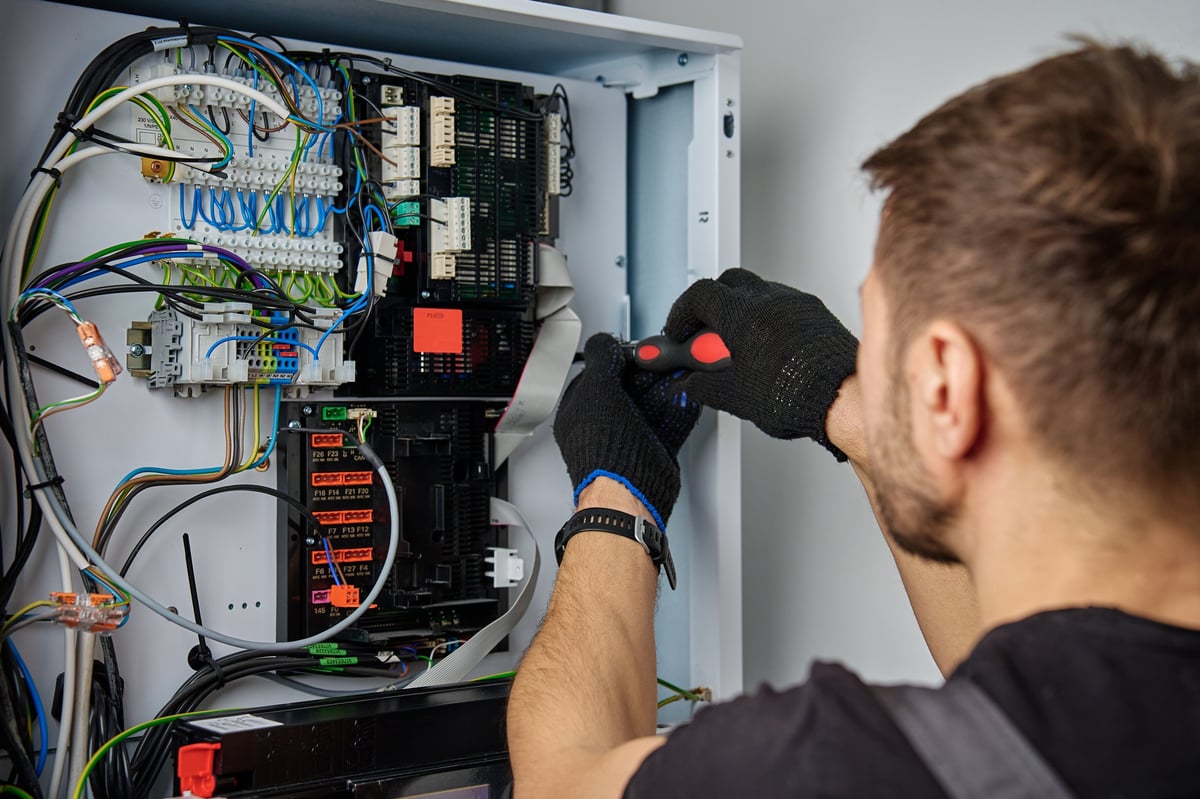 HVAC technician inspecting electrical connections