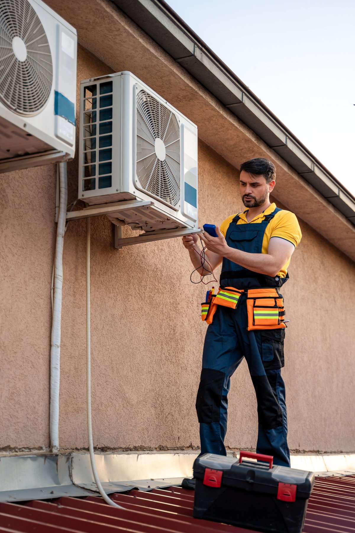 HVAC technician performing maintenance on rooftop unit